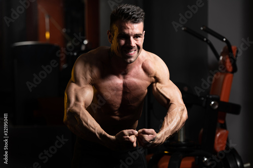 Healthy Young Man Flexing Muscles