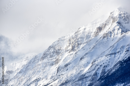 Snow covered mountain in clouds