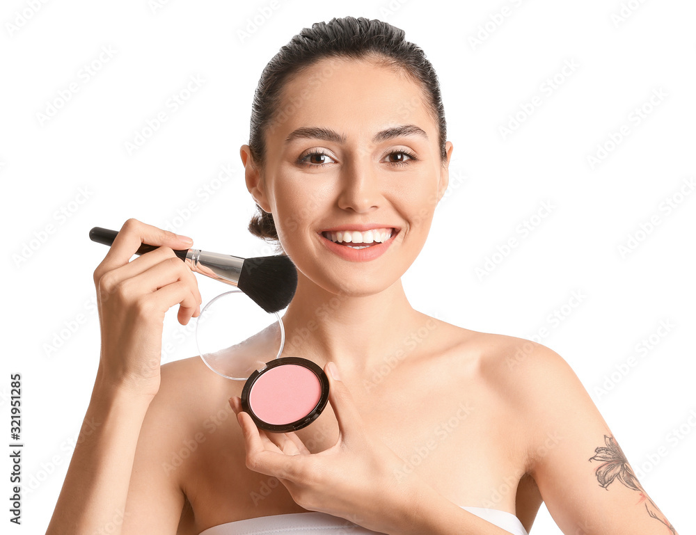 Beautiful young woman applying makeup on white background Beautiful young woman applying makeup on white background