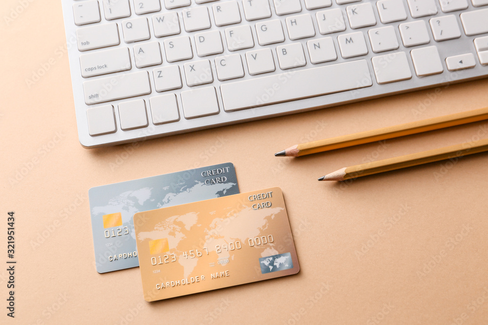Credit cards with computer keyboard on color background. Concept of online banking Credit cards with computer keyboard on color background. Concept of online banking