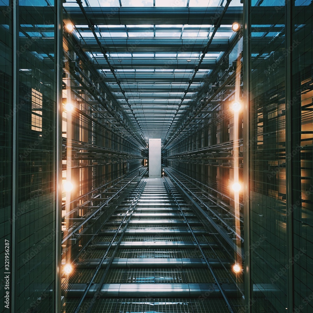 Vertical shot of an illuminated data center storage and network server room - obrazy, fototapety, plakaty 