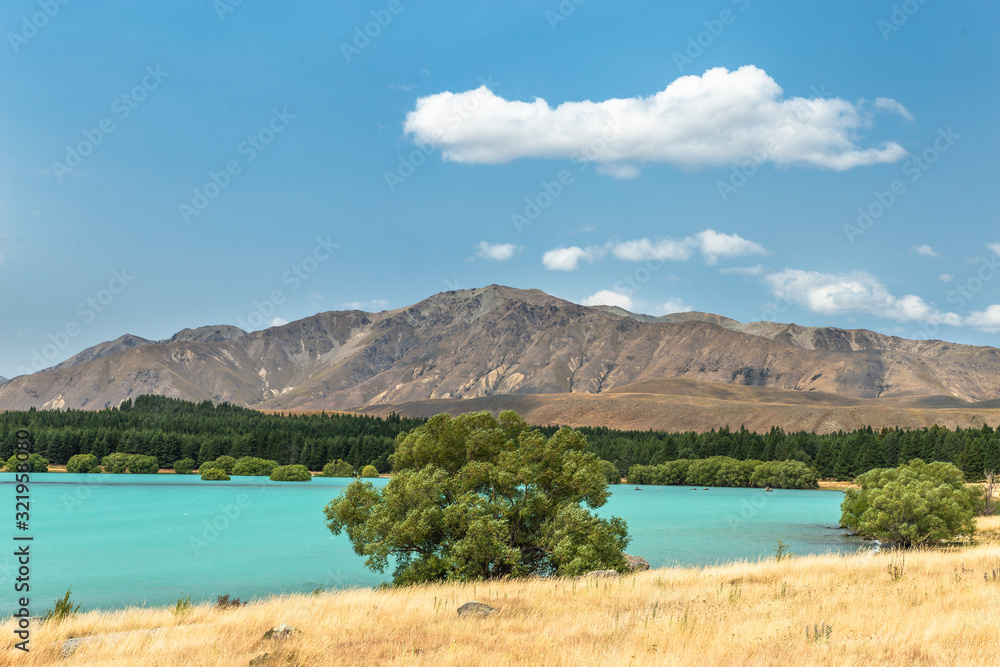 Blue water lake landscape with mountains and clear sky, Lake Tekapo, New Zealand