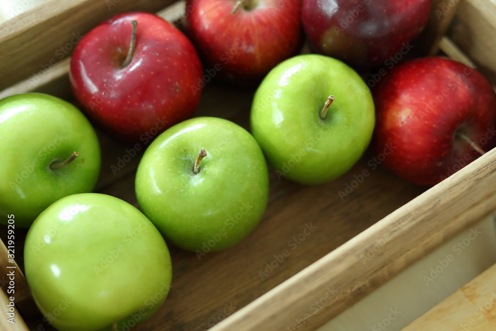 red and green apple fruit in harvest wood basket red and green apple fruit in harvest wood basket