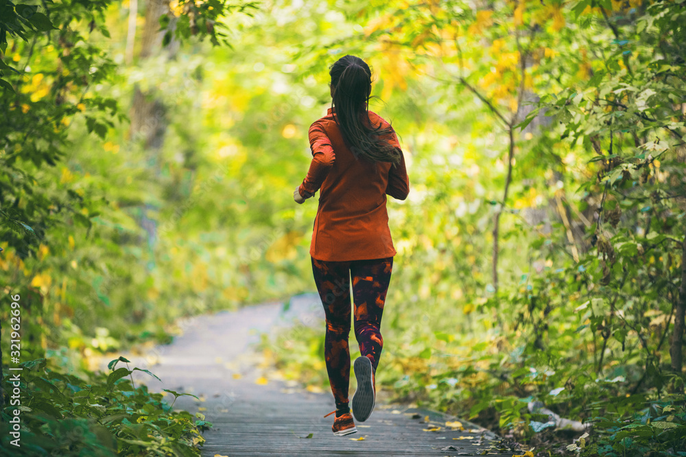 Run fit runner woman jogging in green spring forest woods park, healthy