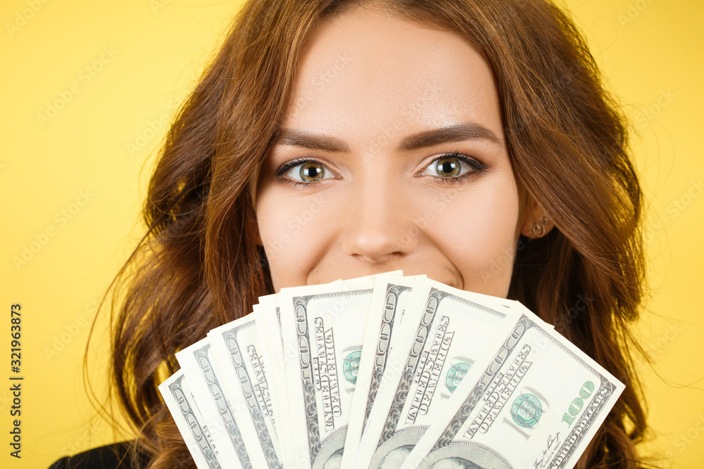 happy woman with money in hand, yellow background happy woman with money in hand, yellow background