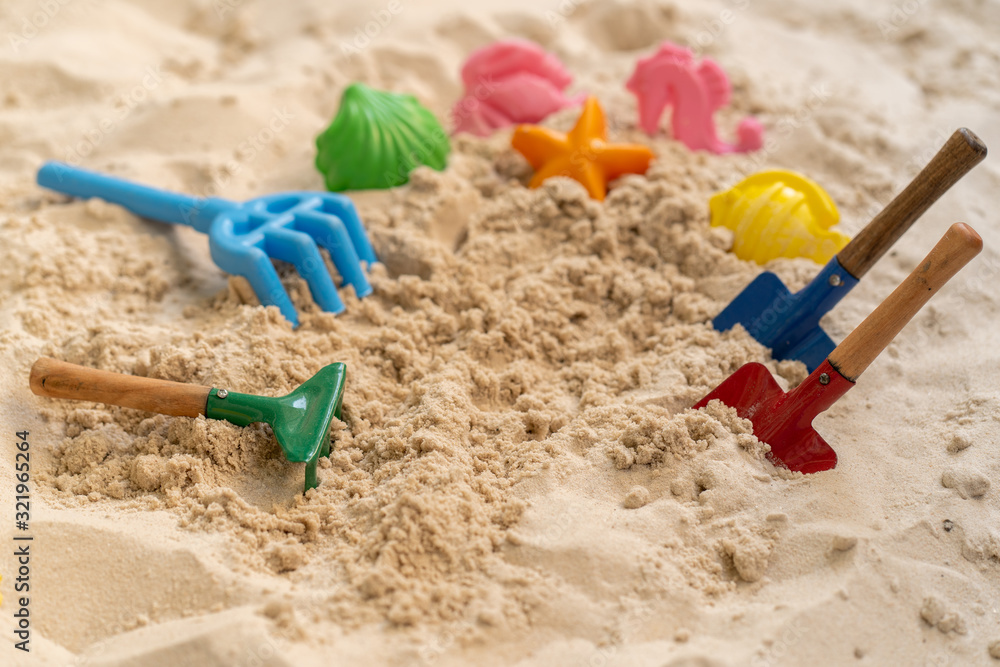 Plastic children toys in sandpit outdoor. Plastic children toys in sandpit outdoor.