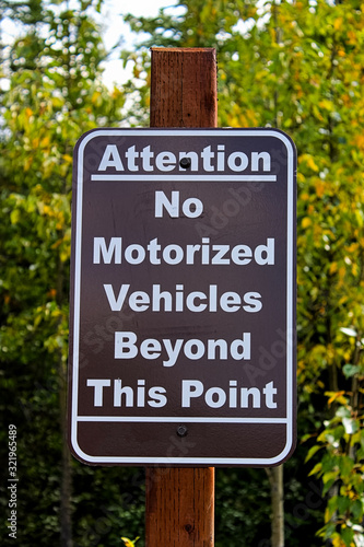 An attention no motorized vehciles beyond this point sign photo