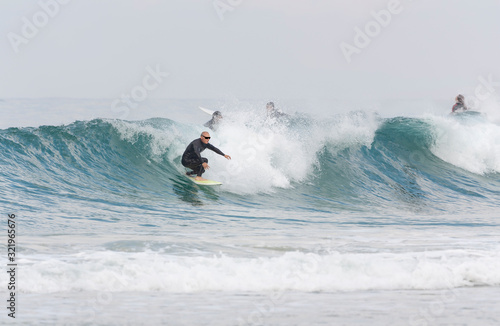 A man over 60 years old riding a surfboard photo