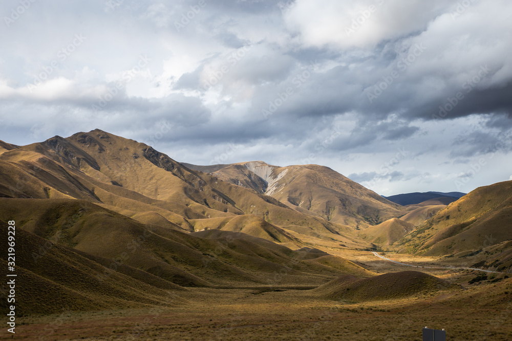 Mountain Road Landscape, Wide Scenic View of Popular Travel Route Lindis Pass New Zealand Mountain Road Landscape, Wide Scenic View of Popular Travel Route Lindis Pass New Zealand