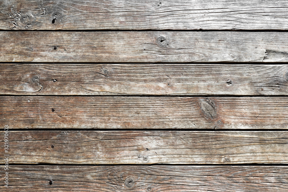 Close-up of wooden wall of rural house. Old, dry, weathered boards with deep cracks, with rusty nails driven in. Texture of wood. Abstract background. For design. empty template Close-up of wooden wall of rural house. Old, dry, weathered boards with deep cracks, with rusty nails driven in. Texture of wood. Abstract background. For design. empty template