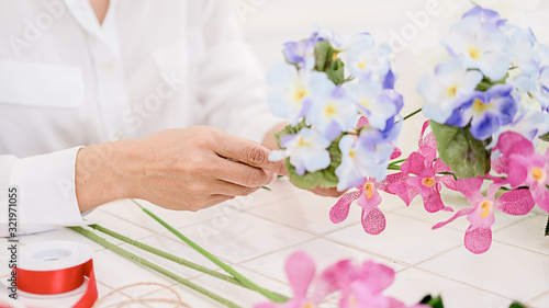 Flower shop staff arrange flowers as ordered for valentines.