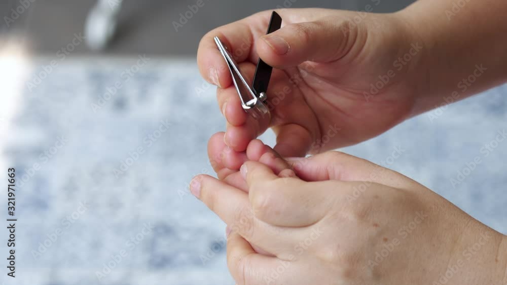 Mother cutting her child's toenails at home Mother cutting her child's toenails at home