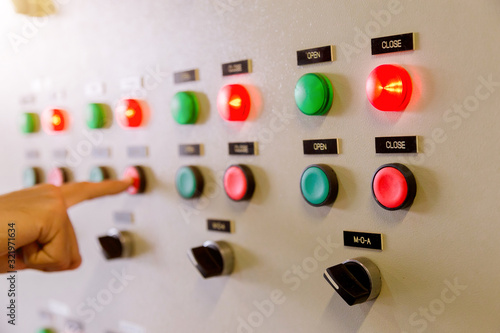 Engineer working on checking and maintenance electrical equipment engineer checking status switchgear with checklist System ready. photo