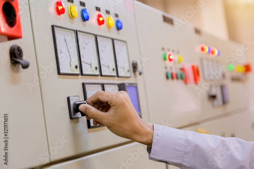 Engineer working on checking and maintenance electrical equipment engineer checking status switchgear with checklist System ready. photo