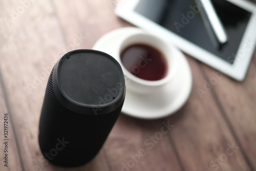 top view of smart speaker with tea and digital tablet on table 