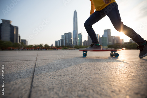 Skateboarder skateboarding at sunset city photo