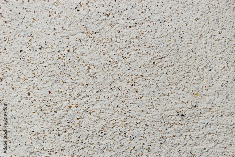 A grunge texture background of an old  stone relief wall with small spots