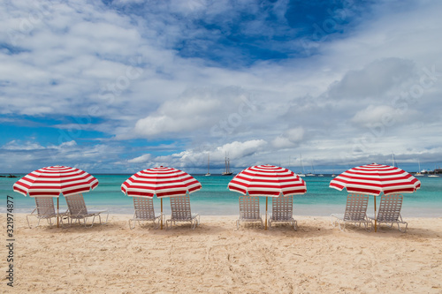 Red beach chairs, umbrellas and ocean view