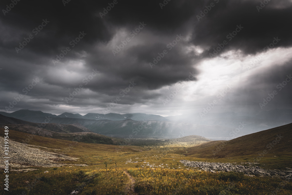 Mountain landscape. A ray of the sun breaks through the clouds Mountain landscape. A ray of the sun breaks through the clouds