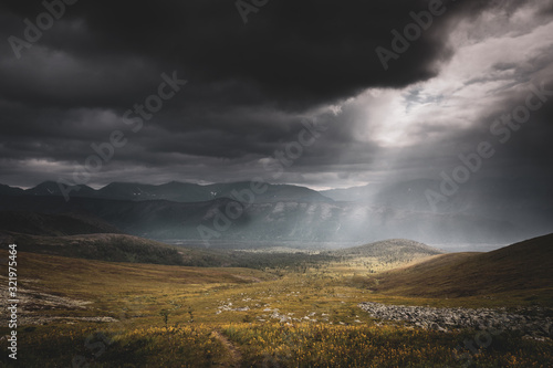 Mountain landscape. A ray of the sun breaks through the clouds