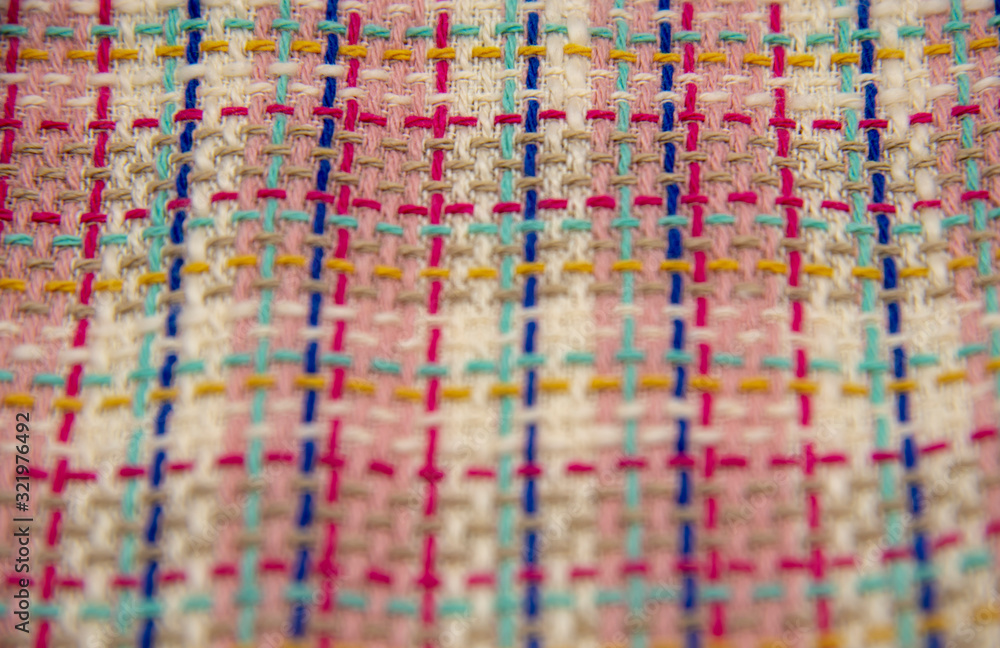 Abstract multicolor cloth texture, close up fashion background. Multicolored plaid tweed fabric.