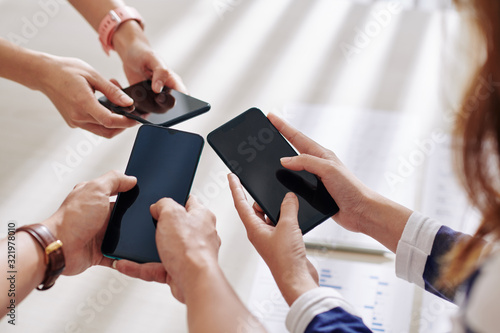 Group of business people using applications on smartphones for communication