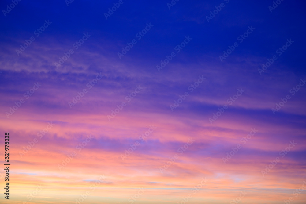 Photo of a dark sky in the early autumn morning with colorful clouds