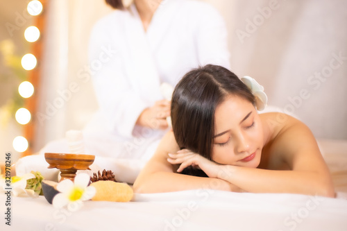 Asian Beautiful, young and healthy woman in spa salon. Massage treatment spa room  . Traditional medicine and healing concept.