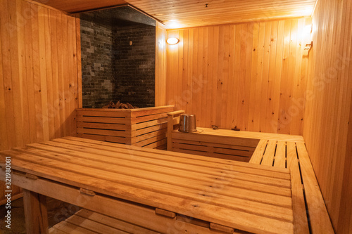 Sauna wooden, stones and lamps, bucket table comfortably