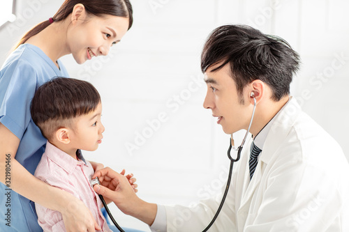 medical doctor examining  little boy  in clinic