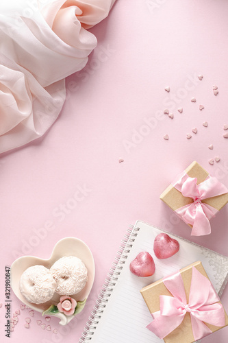 Gift box or gift box and flowers on pink table top view. Flat lay. Birthday, wedding, valentines day, march 8th concept. copy space