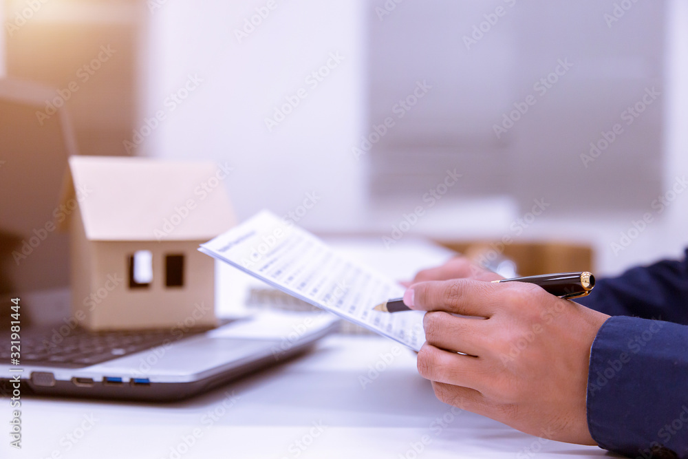 Male business man reading a document to make a financial statement with the bank. Male business man reading a document to make a financial statement with the bank.