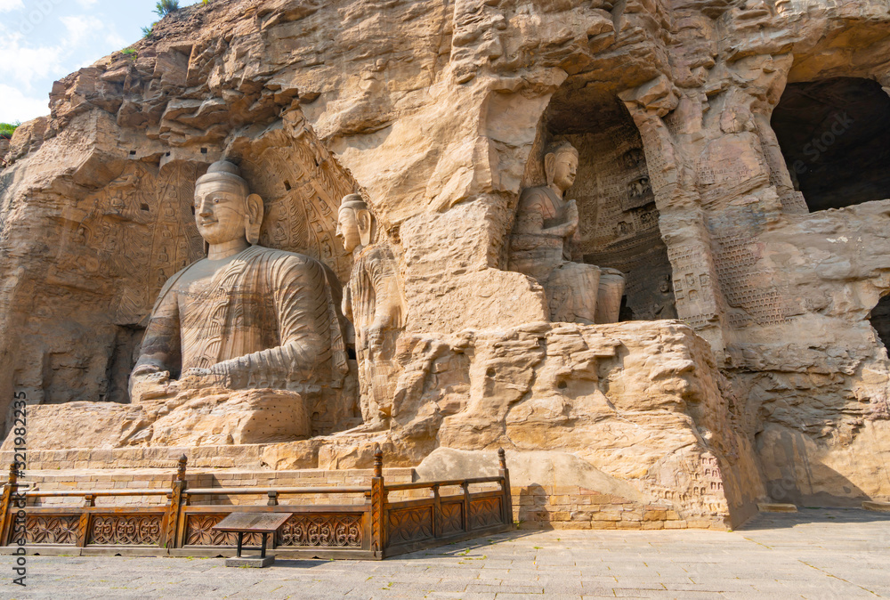 Bid buddha statues carved directly on a mountain hill. Yungang Grottoes in Datong, Shanxi Province, China