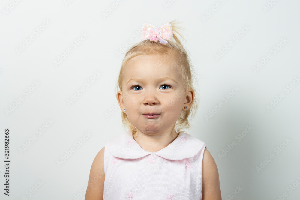 Little girl on a light background. Banner. Concept little model, princess Little girl on a light background. Banner. Concept little model, princess