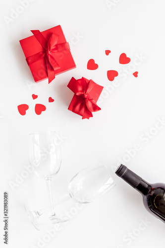 Valentines Day concept with wine and red present box on white background top-down