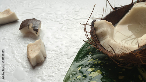 Chopped coconut and coconut pulp on a white wooden table. Coconut and Coconut milk on a light table. Healthy eating concept. Vegan non dairy. photo