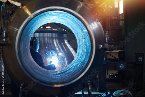 A welder works at an engineering plant.