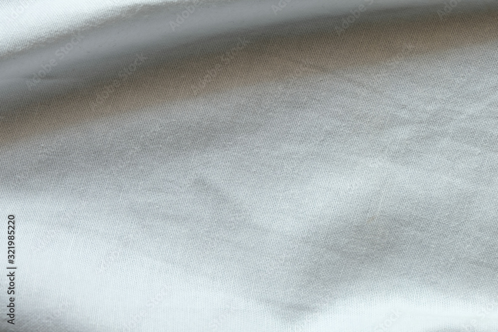 Wrinkled White fabric close up shot of good quality Cotton and polyester shirt. formal wear for office worker . Background texture concept with copy space for text. Wrinkled White fabric close up shot of good quality Cotton and polyester shirt. formal wear for office worker . Background texture concept with copy space for text.