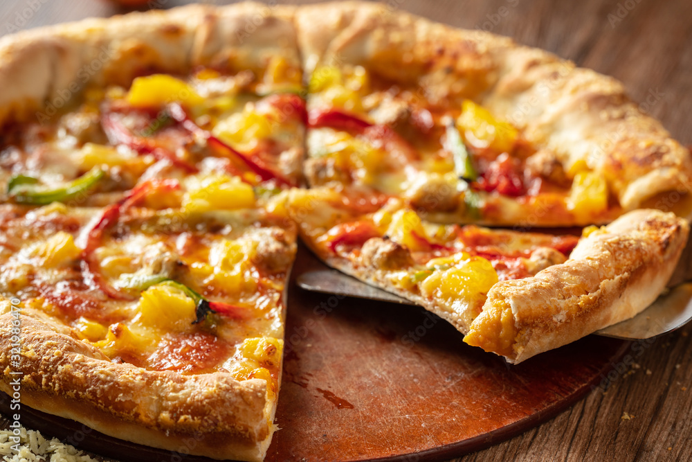 whole italian pizza on wood table with ingredients whole italian pizza on wood table with ingredients