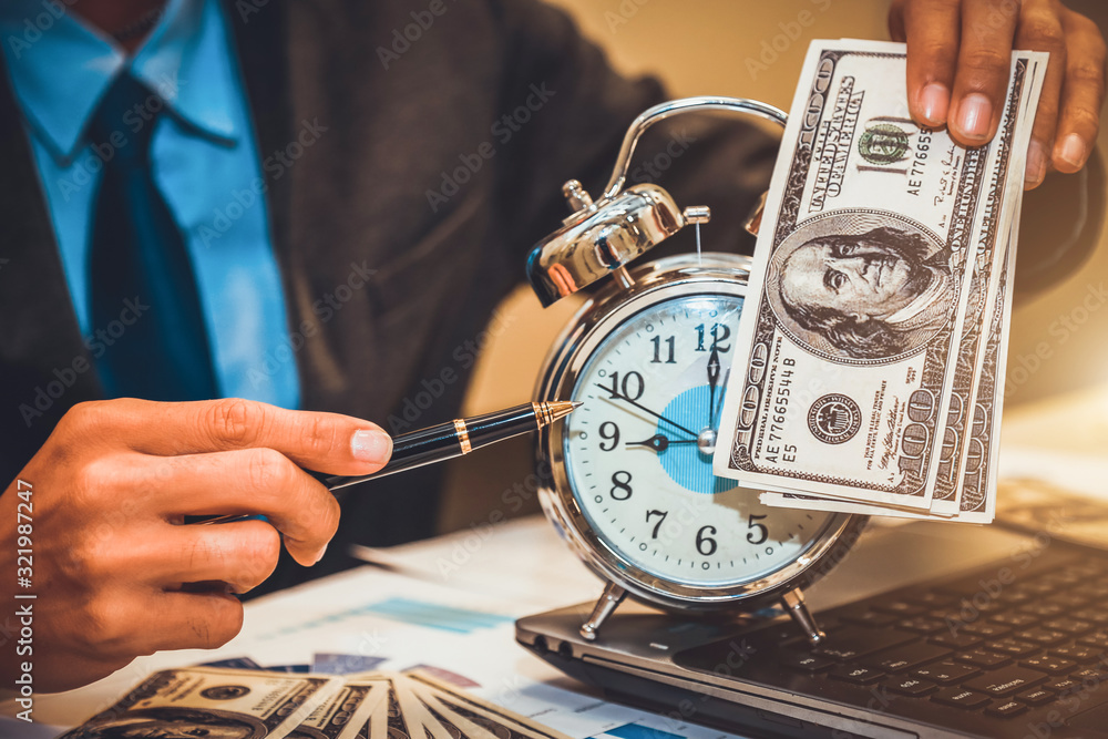Business holding money and clock. time is money concept.