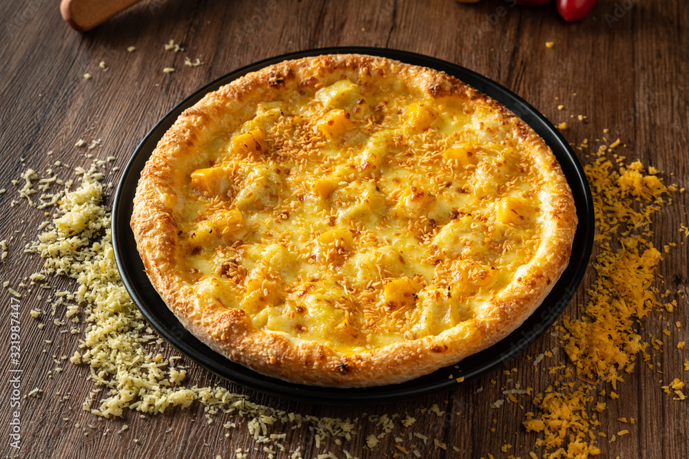 whole italian pizza on wood table with ingredients