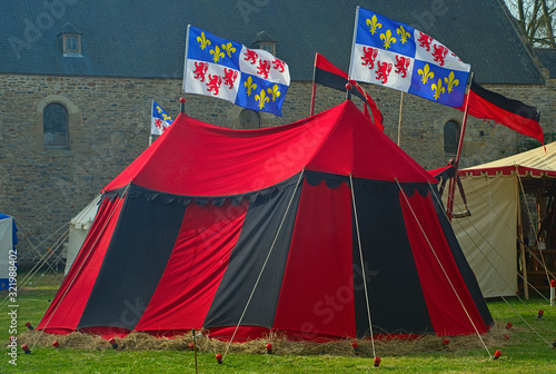 Medieval red and black war tent with normandy flags waving © Zeljko