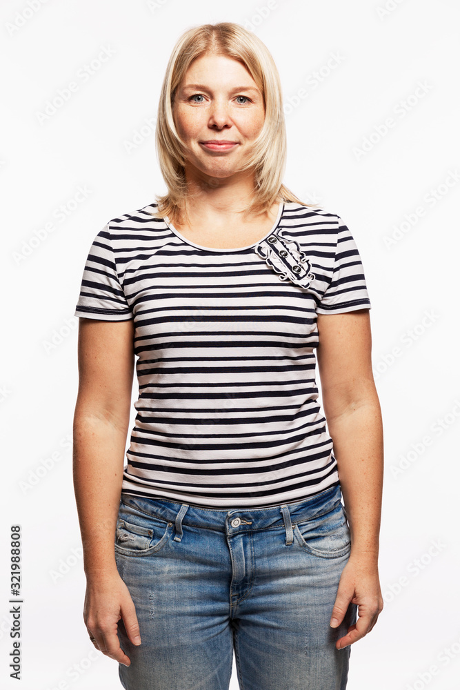 Obraz premium Young blond woman in jeans. White background. Vertical.