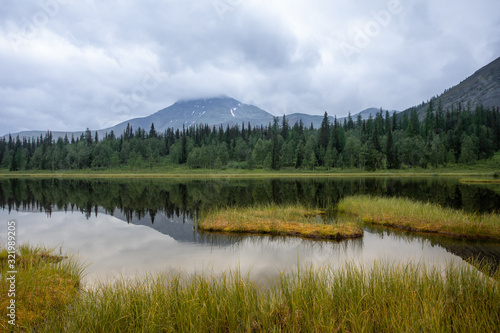 Mountain lake in the taiga. Mountains of the Subpolar Urals.