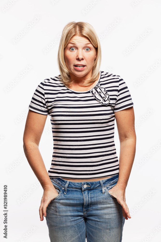 Obraz premium Young blond woman in jeans screaming. White background. Vertical.