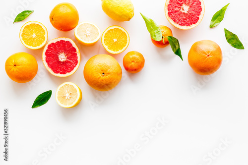 Fresh citrus frame. Oranges  tangerines  grapefruits  leaves on white background top-down copy space