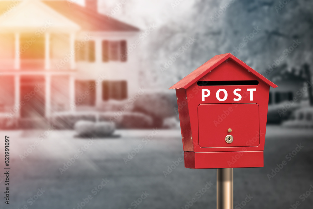 Red mailbox standing in front of house Red mailbox standing in front of house