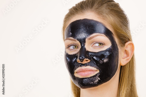 Girl black carbo peel off mask on face