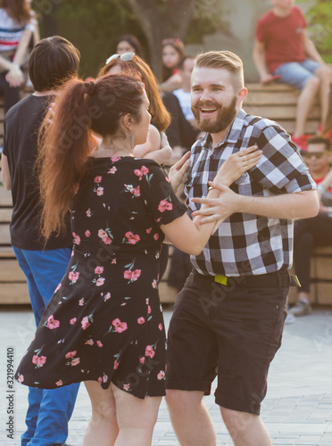 Kizomba, bachata or salsa concept - beauty couple dancing social dance on open air party.