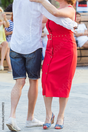 Kizomba, bachata or salsa concept - beauty couple dancing social dance on open air party.